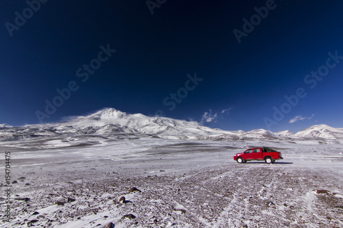 red car near ojos del salado volcano in chile