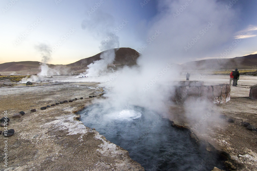 geyser tatio with water surface at sunrise