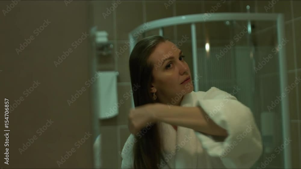 Girl combing her hair before a mirror Girl combing her hair before a mirror