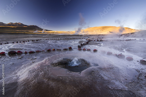 geyser tatio with water surface at sunrise photo