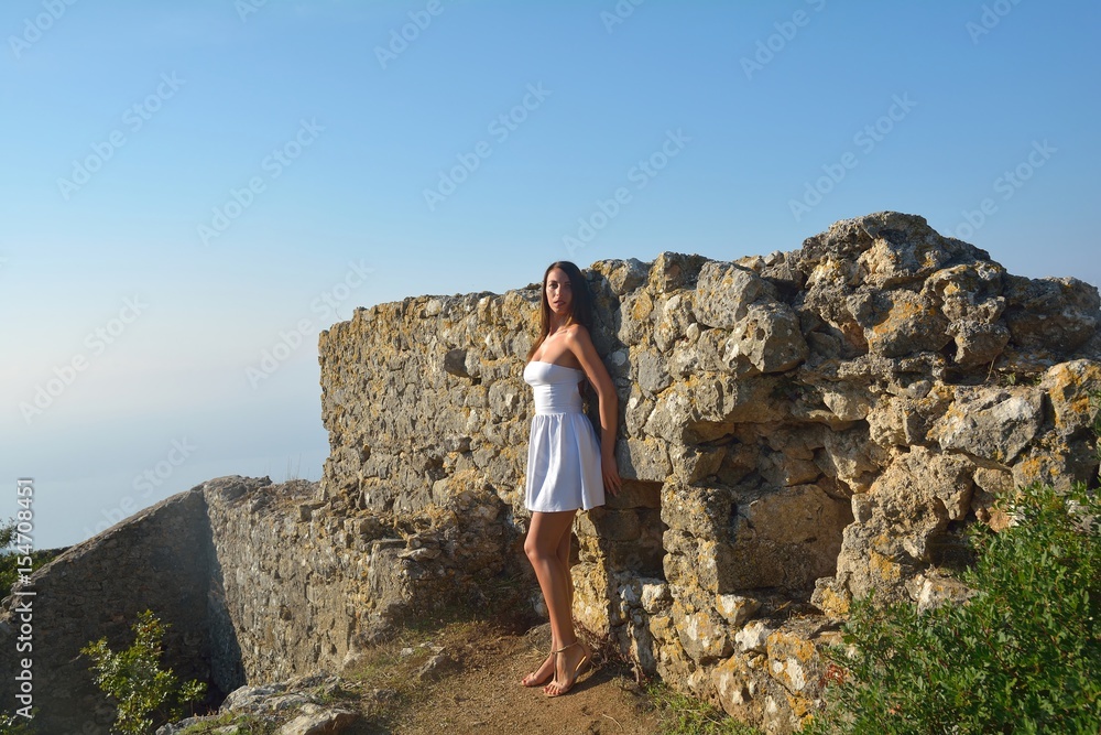 Attractive girl on old ruins in summer