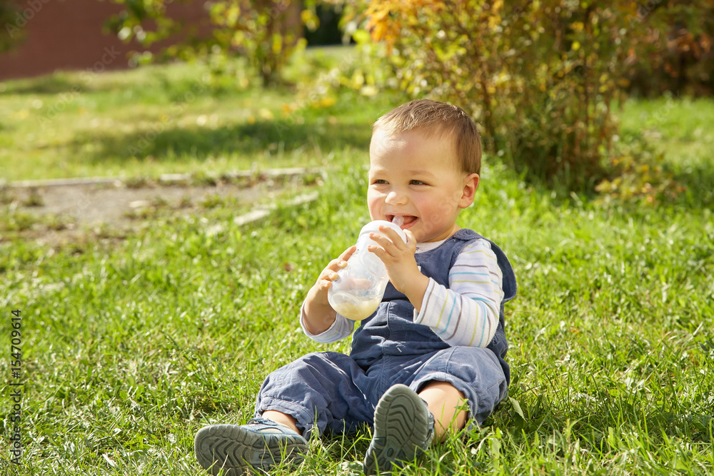 boy sitting on the grass boy sitting on the grass