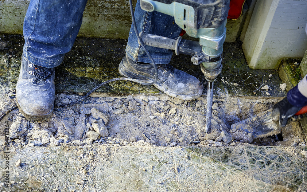 Workers perform small excavation work with tools during new fiber optic construction work. closeup with blurred motion