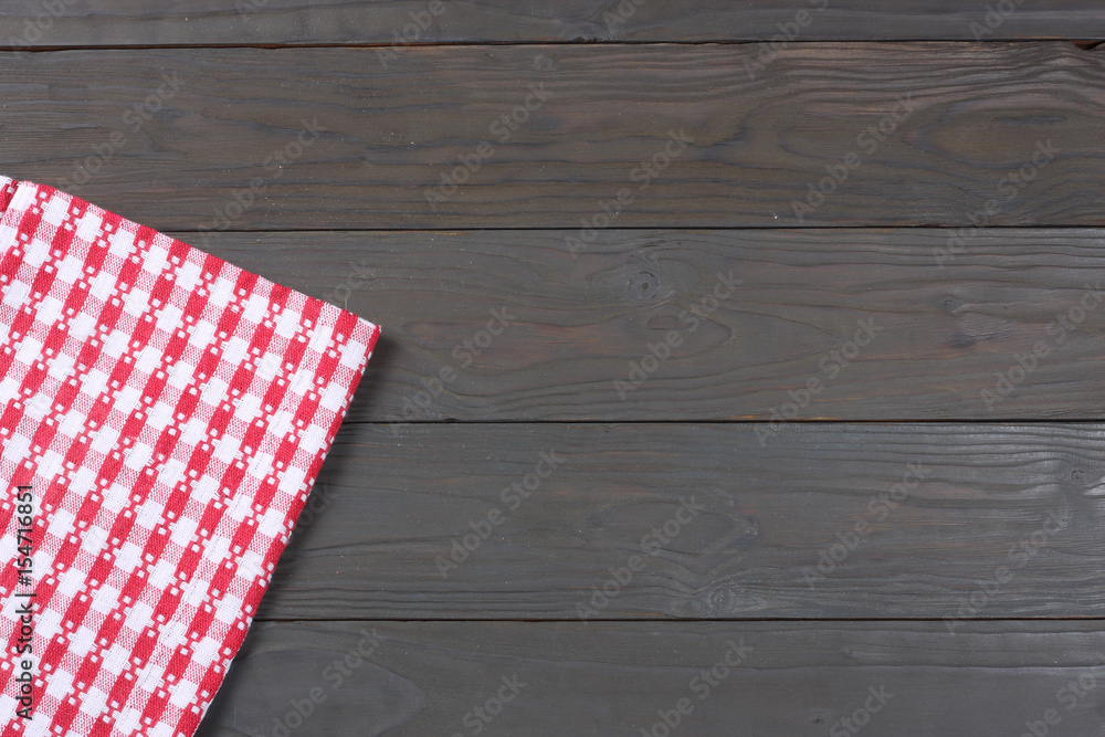 Obraz premium red cloth on dark wooden background with copy space. Top view.