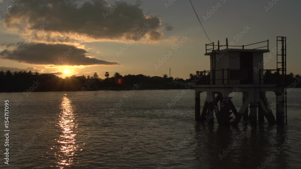 Pathein, sunset at the Irrawaddy river with small fishing boats Pathein, sunset at the Irrawaddy river with small fishing boats