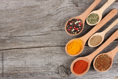 Herbs and spices on wooden background. Top view with copy space
