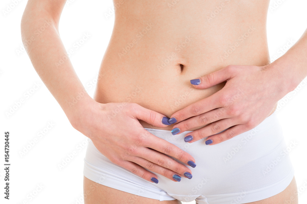 Woman with hands on belly. Stomach ache. Studio photo isolated on white background