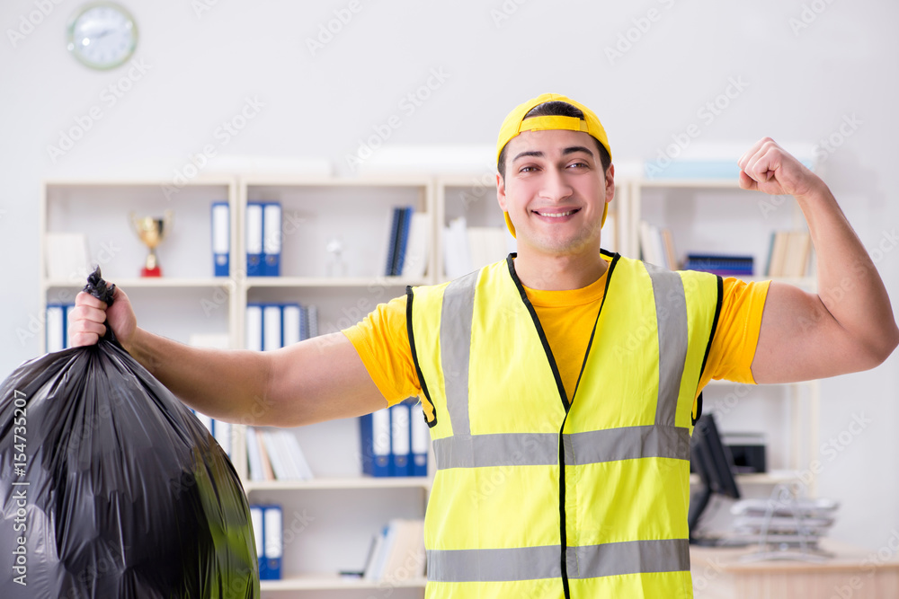 Man cleaning the office and holding garbage bag Man cleaning the office and holding garbage bag