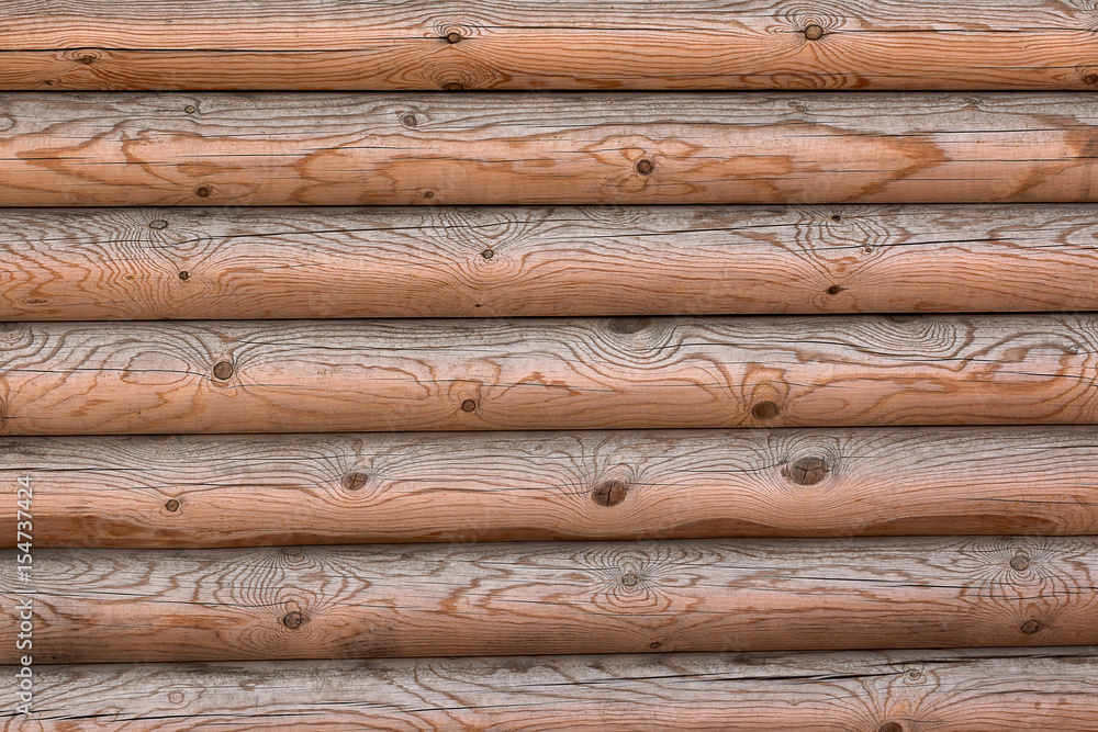 The wall of a wooden house from calibrated logs The wall of a wooden house from calibrated logs