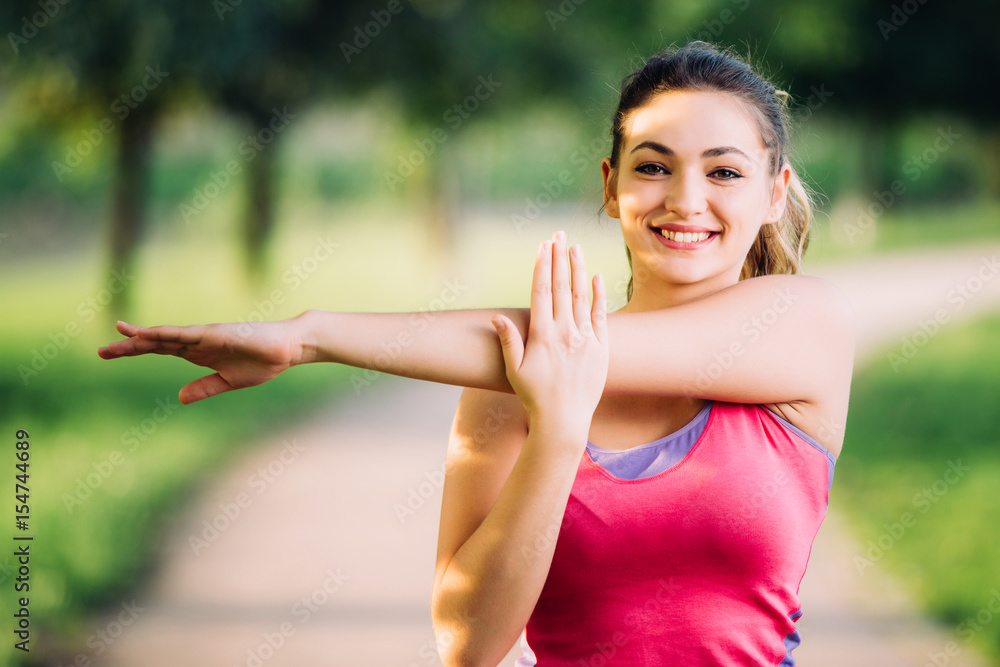 Woman is stretching before jogging. Fitness and lifestyle concept. Woman is stretching before jogging. Fitness and lifestyle concept.