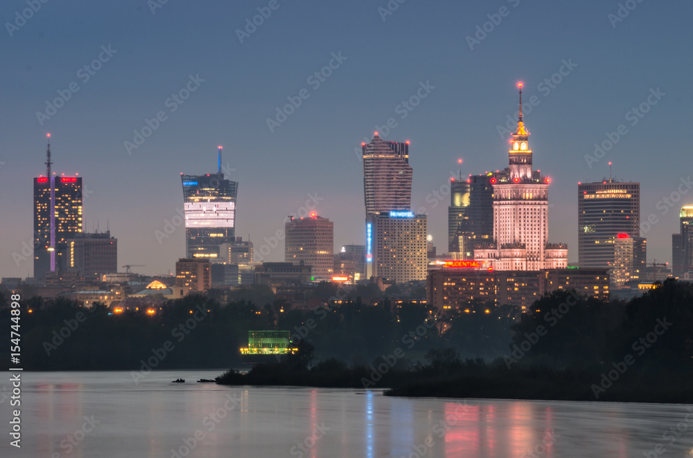 Fototapeta Night panorama of Warsaw skyline, Poland, over Vistula river in the night