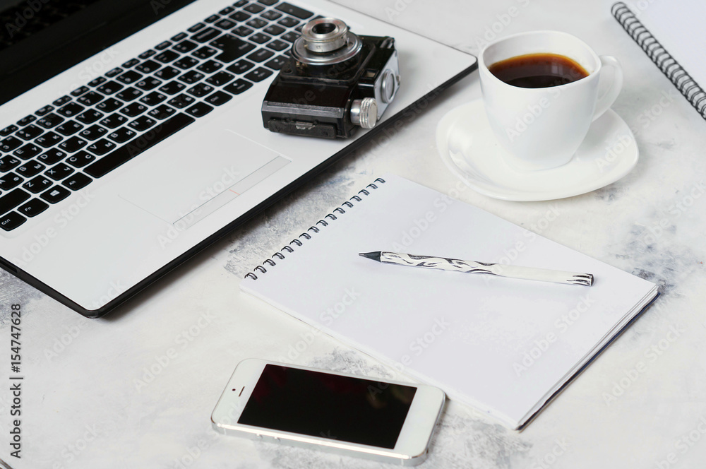 Office Desk with computer, phone, camera, Cup of coffee and peony flowers. Coffee break, ideas, notes or plan of writing concept. White background. The view from the top Office Desk with computer, phone, camera, Cup of coffee and peony flowers. Coffee break, ideas, notes or plan of writing concept. White background. The view from the top