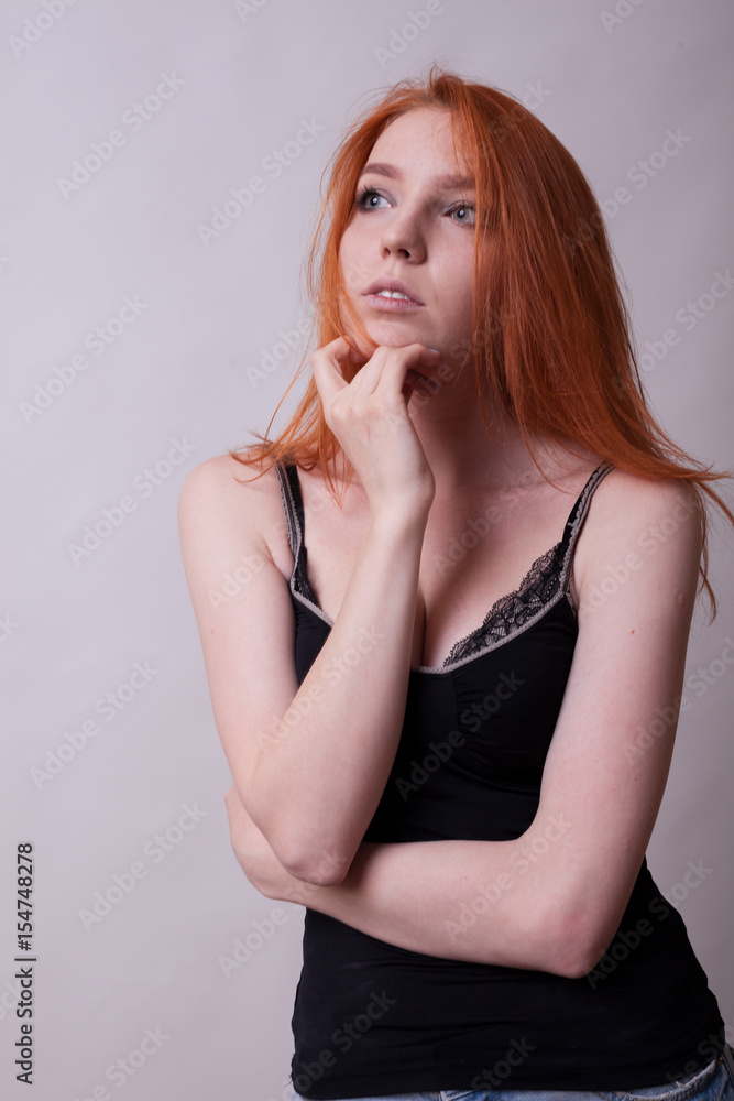 Gorgeous busty woman in studio photo on gray background. Sexuality and sensuality. Attractive model Gorgeous busty woman in studio photo on gray background. Sexuality and sensuality. Attractive model