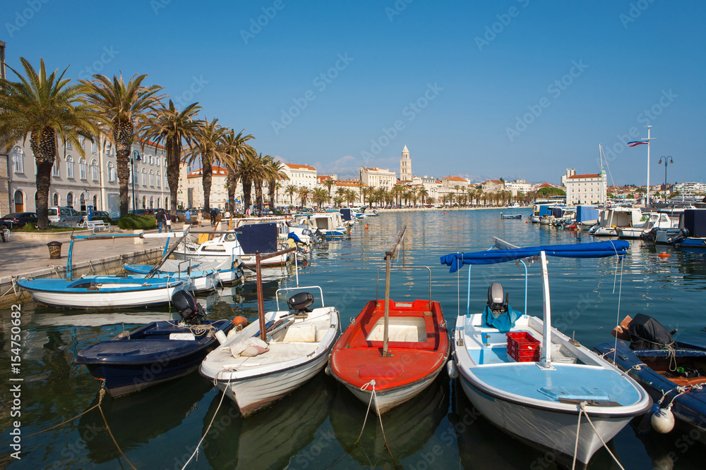 Split city's harbor with colorful boats and the Diocletian Palace in the background