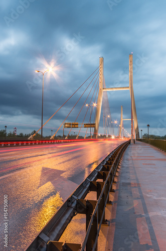 Car light trails on modern bridge during storm - Warsaw, Siekierkowski bridge