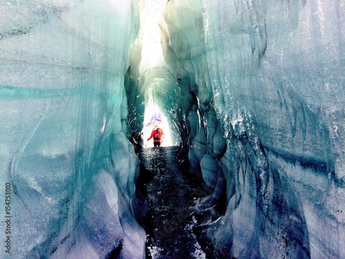Climbing through a deep glacier cravasse photo