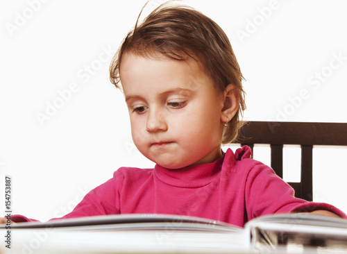 young cute iful baby girl is preparing for exam (humorous photo) (Education, knowledge, school, college, university concept) photo