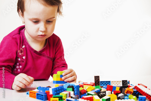  little cute girl playing indoors (developmental toys for children)