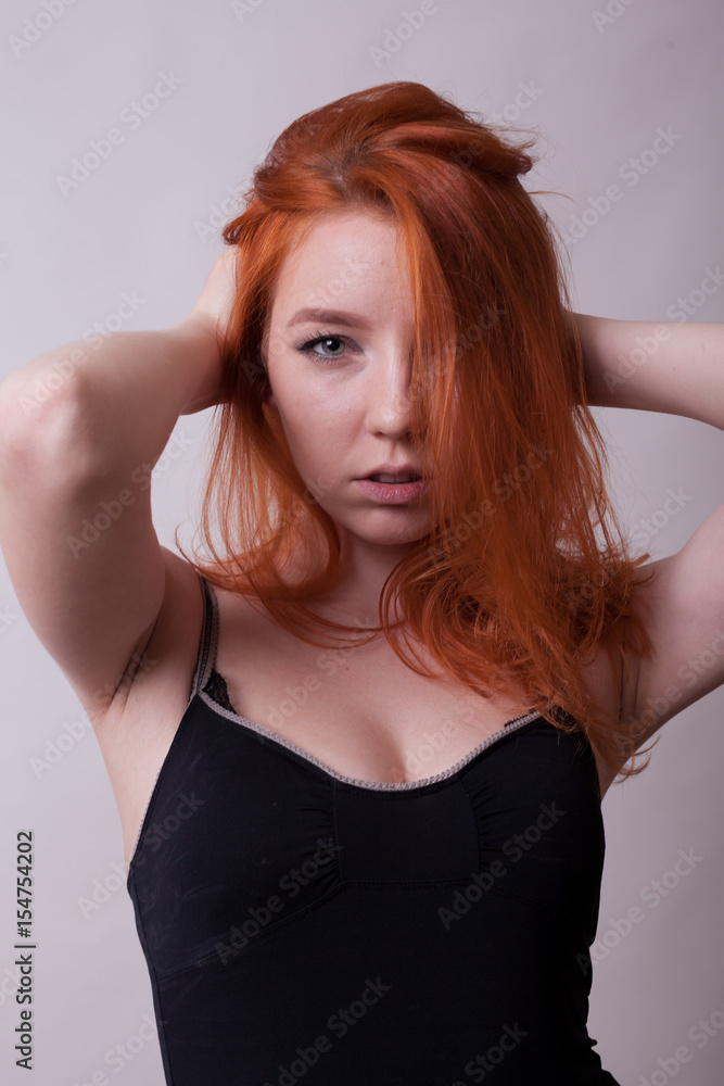 Beautifu hotl busty woman in studio photo on gray background. Sexuality and sensuality. Attractive model Beautifu hotl busty woman in studio photo on gray background. Sexuality and sensuality. Attractive model