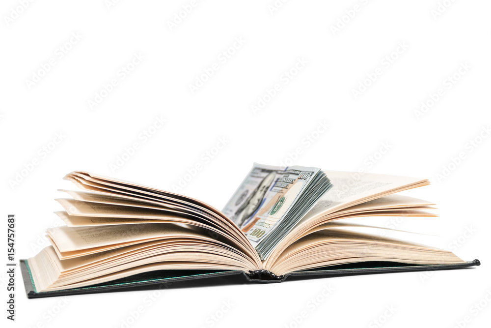 Open book with a stack of dollars lying in it, isolated on a white background Open book with a stack of dollars lying in it, isolated on a white background