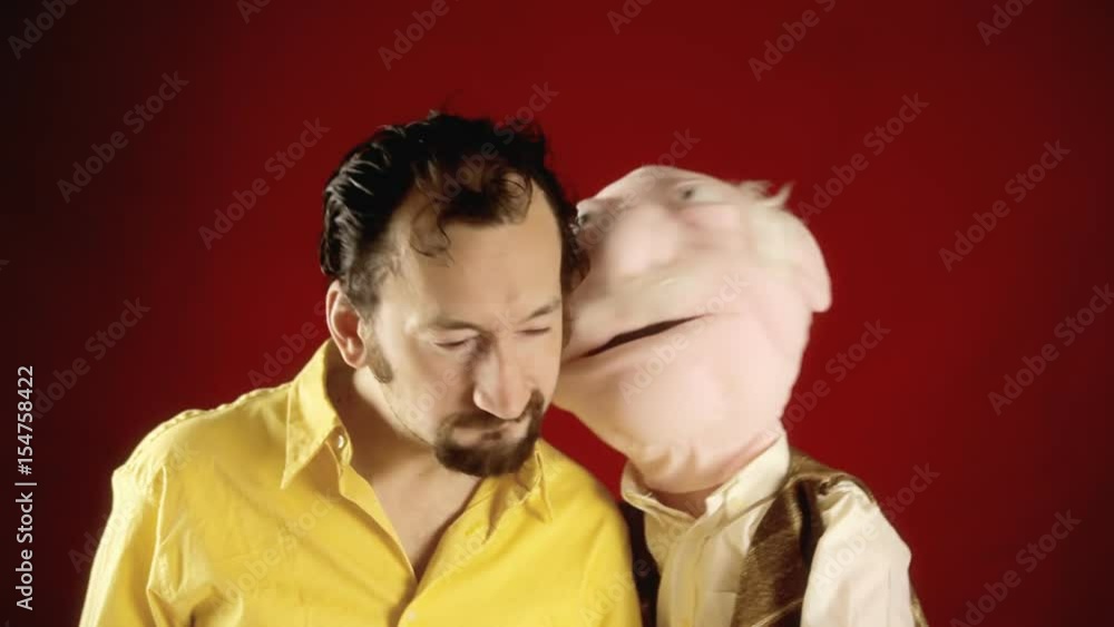 The puppet of an old man telling secrets to a funny ugly guy.
The puppet of an old man telling secrets to a funny ugly guy.