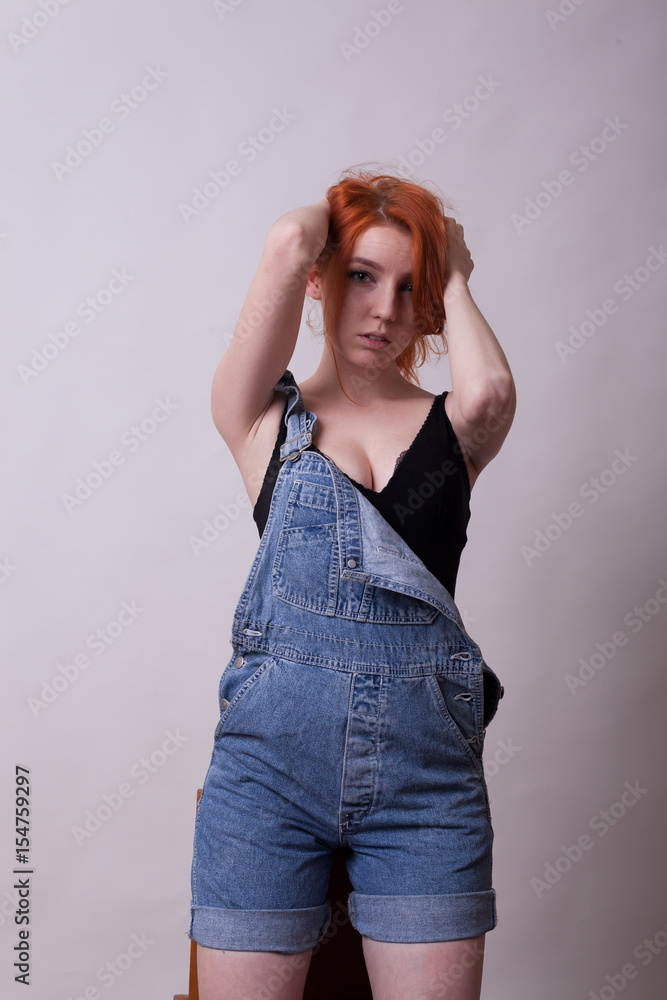 Gorgeous busty redhead woman in studio photo on gray background. Sexuality  and sensuality. Attractive model Photos | Adobe Stock
