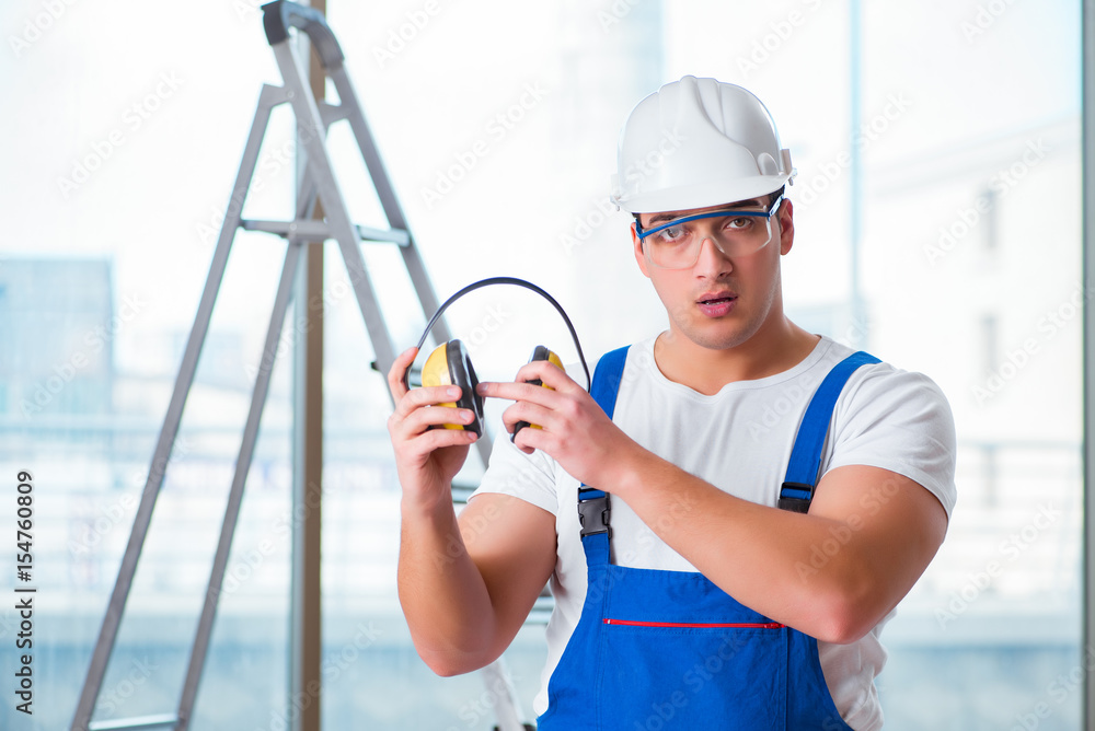Young worker with noise cancelling headphones Young worker with noise cancelling headphones