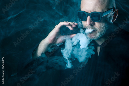 A man smokes an electronic ...
