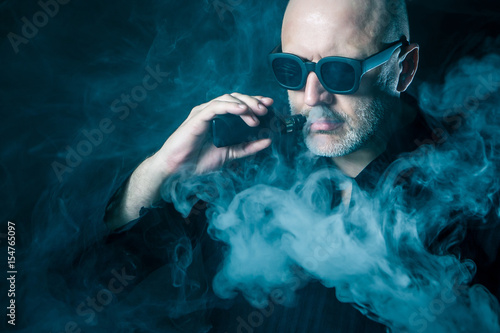 A man smokes an electronic ...