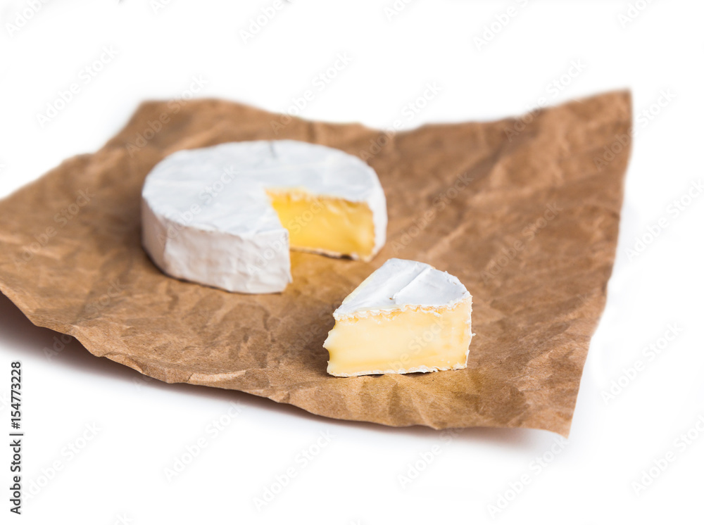 Fresh slice Camembert cheese natural, on Kraft paper