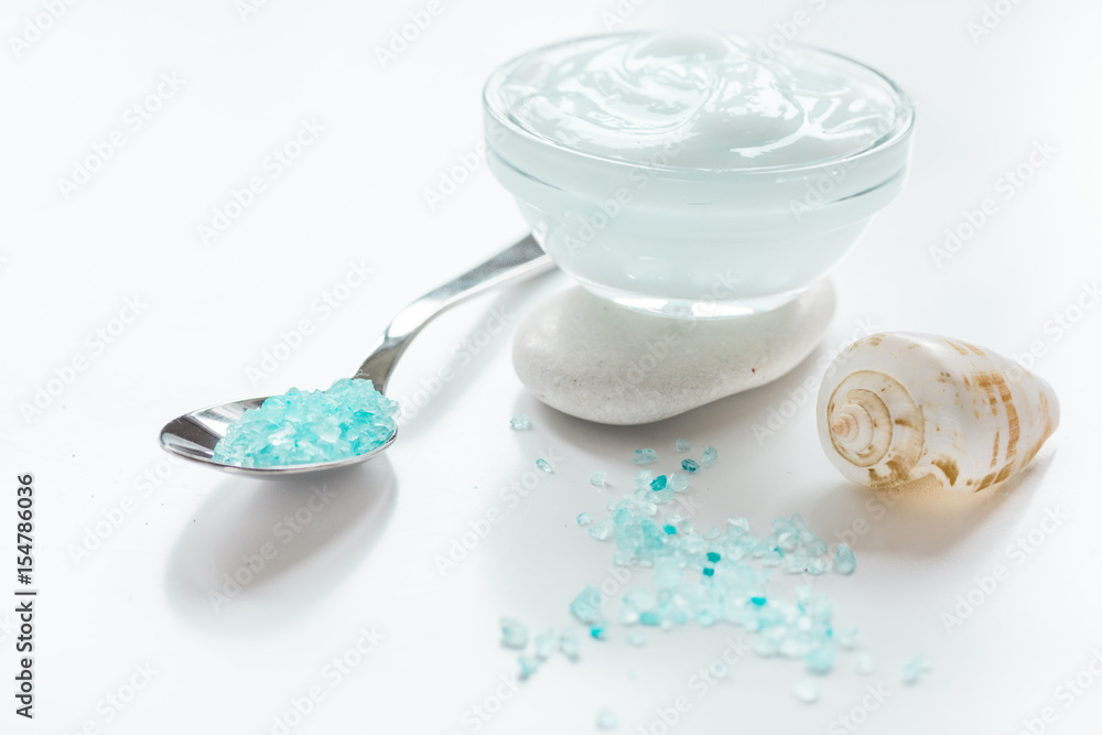 blue sea salt and body cream on white desk background