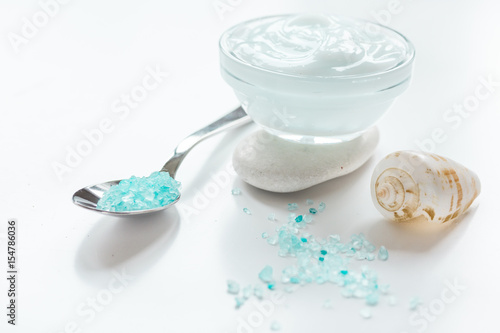 blue sea salt and body cream on white desk background