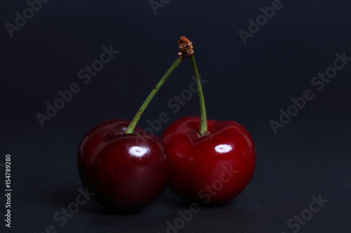 Cherry fresh on black background close up.