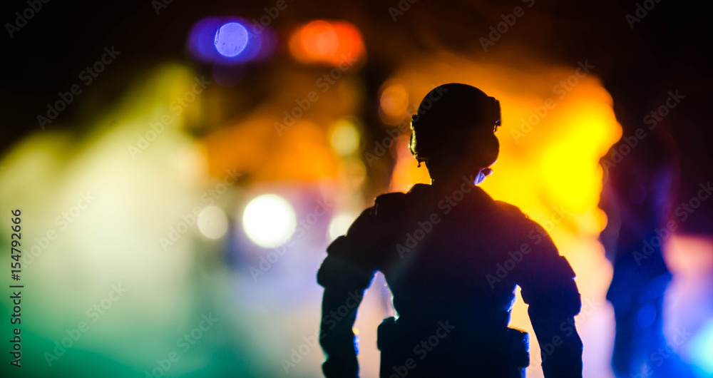 Anti-riot police give signal to be ready. Government power concept. Police in action. Smoke on a dark background with lights. Blue red flashing sirens. Anti-riot police give signal to be ready. Government power concept. Police in action. Smoke on a dark background with lights. Blue red flashing sirens.