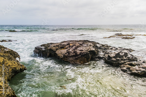 Evening shoreline view with stones.