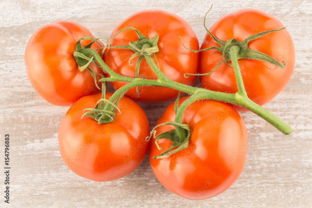 Tomatoes on a white wooden background close up. Tomatoes on a white wooden background close up.