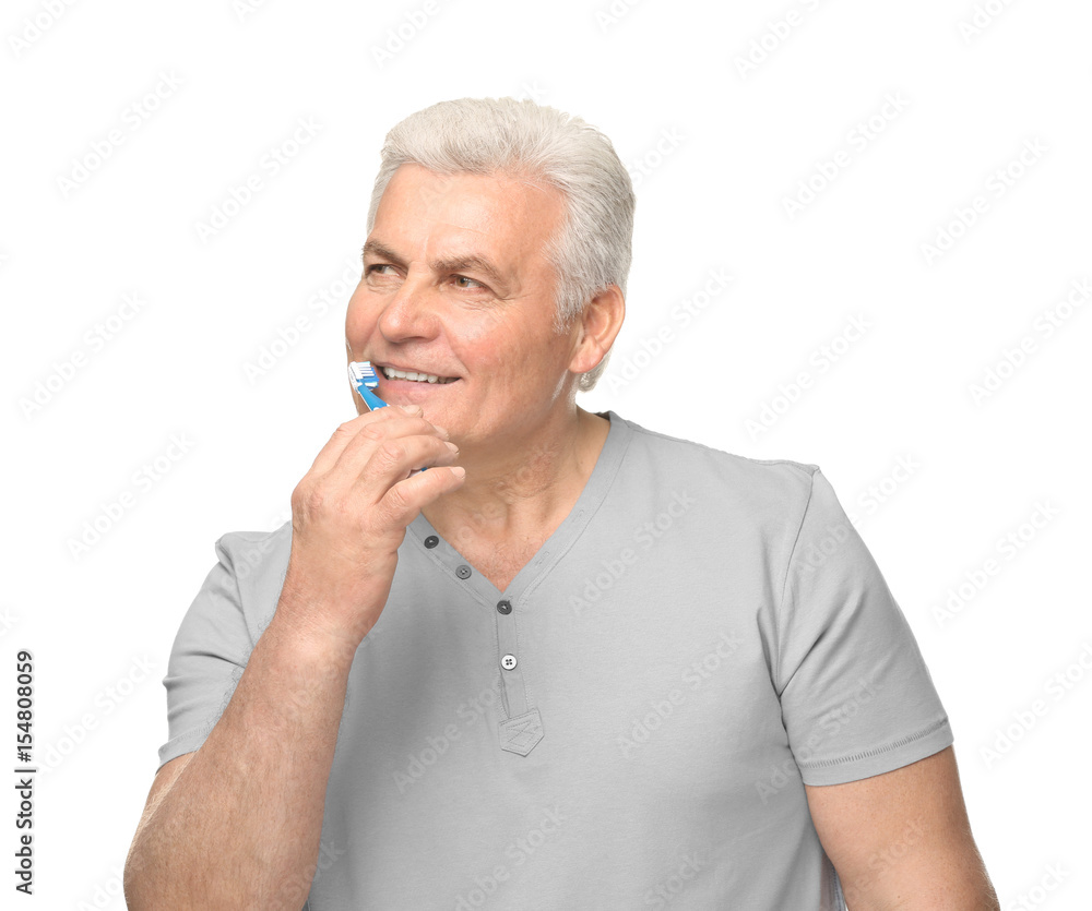 Senior man cleaning teeth on white background Senior man cleaning teeth on white background