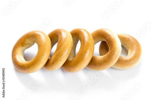 Five dry bagels isolated on white background
