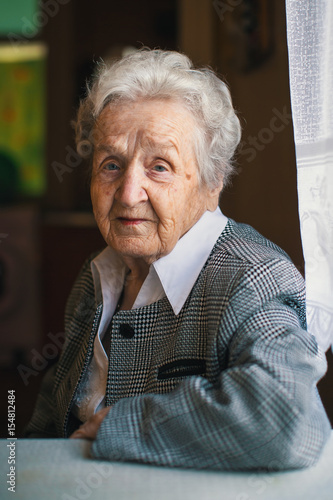 An elderly woman in the his house.