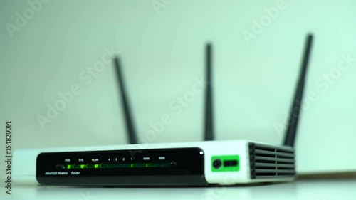Office Wireless Internet Router for Data Packet Transmission at a Distance, with Three Radio Antennas, Different Frequency of the Signal Transmission Band. For Gadget Connections and Office Techniques