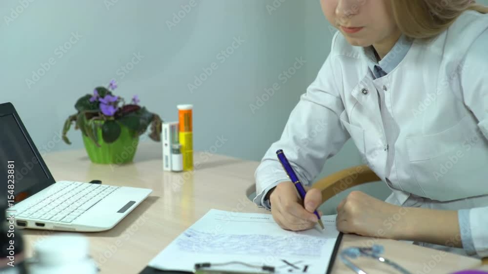 Doctor Writes a Medical Recipe in a Hospital and Use Tablet Computer, pc, notebook, computer or tablet with x-ray (x ray), doctor keeping a medical record. Video can be used like care, clinic, doctor Doctor Writes a Medical Recipe in a Hospital and Use Tablet Computer, pc, notebook, computer or tablet with x-ray (x ray), doctor keeping a medical record. Video can be used like care, clinic, doctor