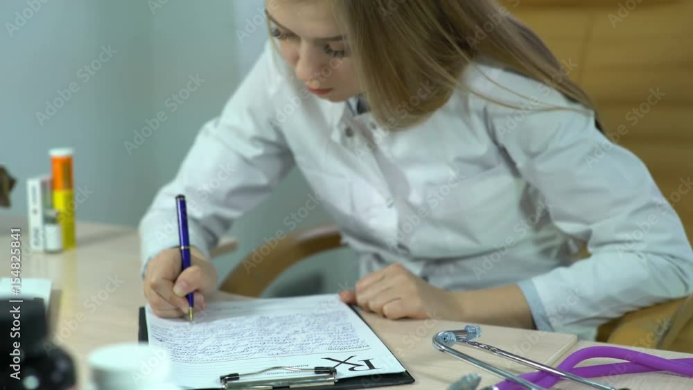 Doctor Writes a Medical Recipe in a Hospital and Use Tablet Computer, pc, notebook, computer or tablet with x-ray (x ray), doctor keeping a medical record. Video can be used like care, clinic, doctor Doctor Writes a Medical Recipe in a Hospital and Use Tablet Computer, pc, notebook, computer or tablet with x-ray (x ray), doctor keeping a medical record. Video can be used like care, clinic, doctor