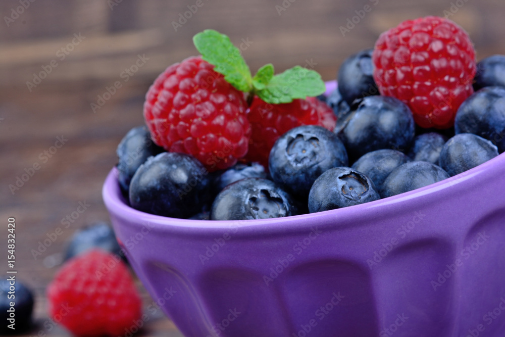 Ceramic bowl with blueberries and raspberries Ceramic bowl with blueberries and raspberries