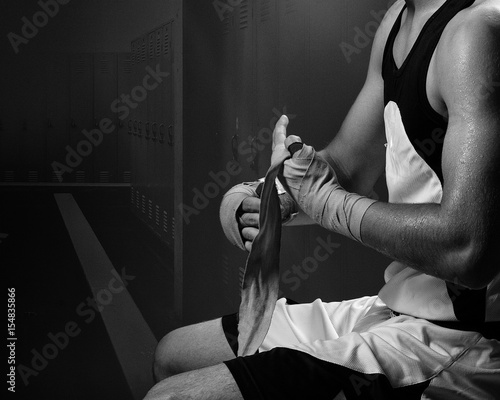 Konstfotografi Boxer preparing for fight taping hands in locker room