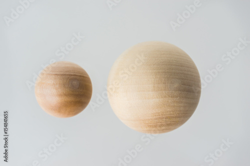 Surreal design concept - real wooden ball float on grey background like the planet on the universe