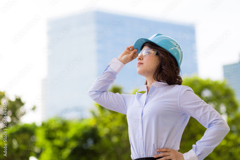 young female engineer looking up to buildings. young female engineer looking up to buildings.