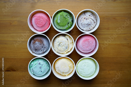 Top view Ice cream flavors in cup on wood table