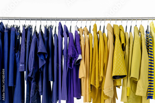 Variety of colorful female yellow and blue clothing on hanging