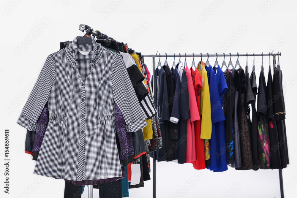 Variety of casual female clothes of different colors on hangers Variety of casual female clothes of different colors on hangers