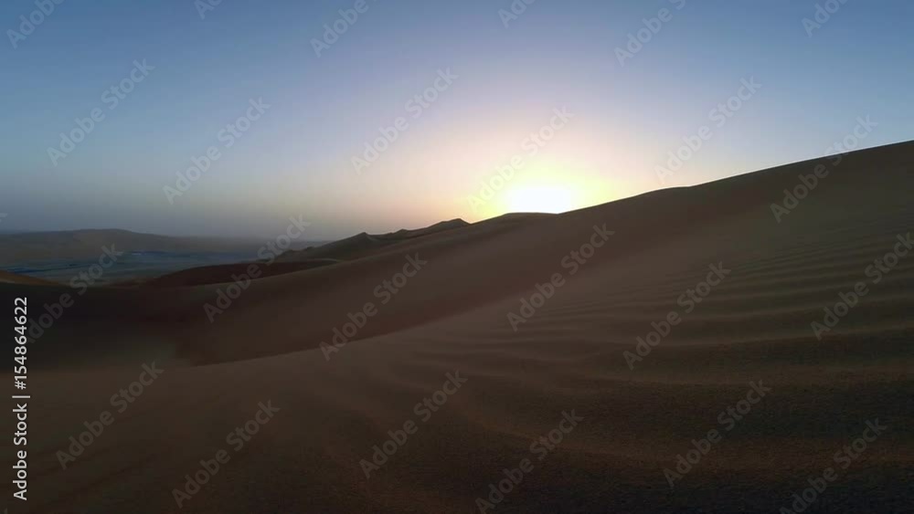 sunrise in Liwa desert, part of Empty Quarter, the largest sand desert in the world sunrise in Liwa desert, part of Empty Quarter, the largest sand desert in the world